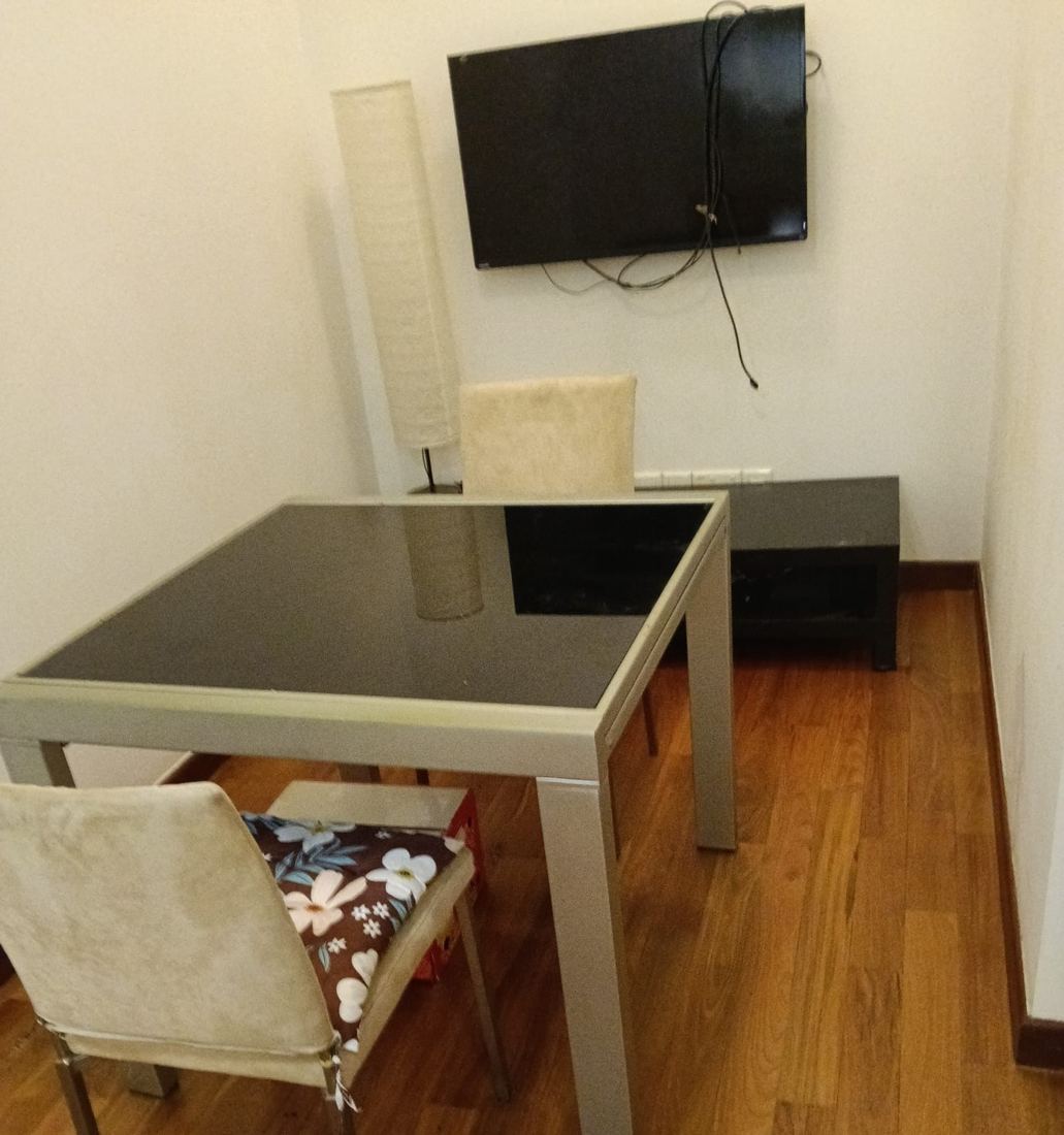 Refinished teak strip floor in a condo dining area