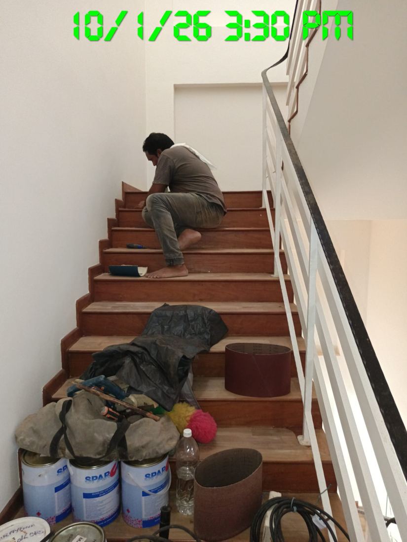 Technician hand-sanding timber stairs